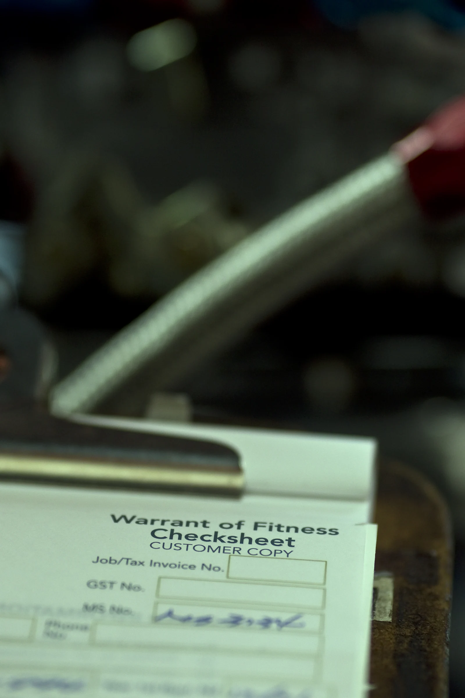 Warrant of Fitness checksheet on a clipboard